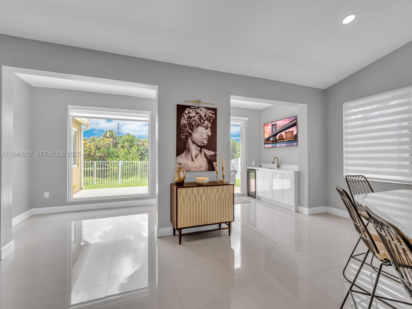 933 Falling Water Road Weston, FL 33326 - Photo 14 of 58 a living room with furniture and a window