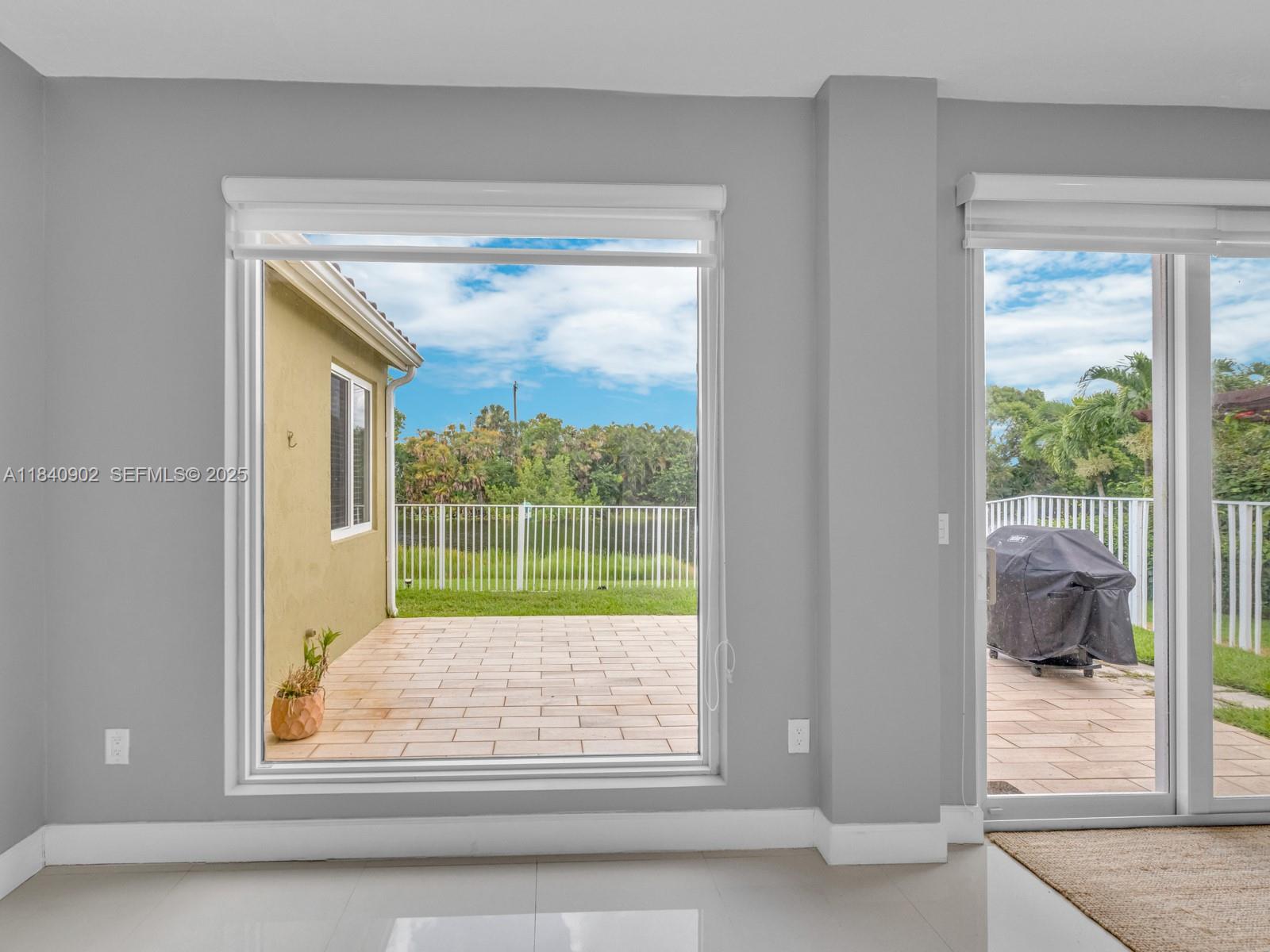 933 Falling Water Road Weston, FL 33326 - Photo 15 of 58 a view of lot of window and wooden floor