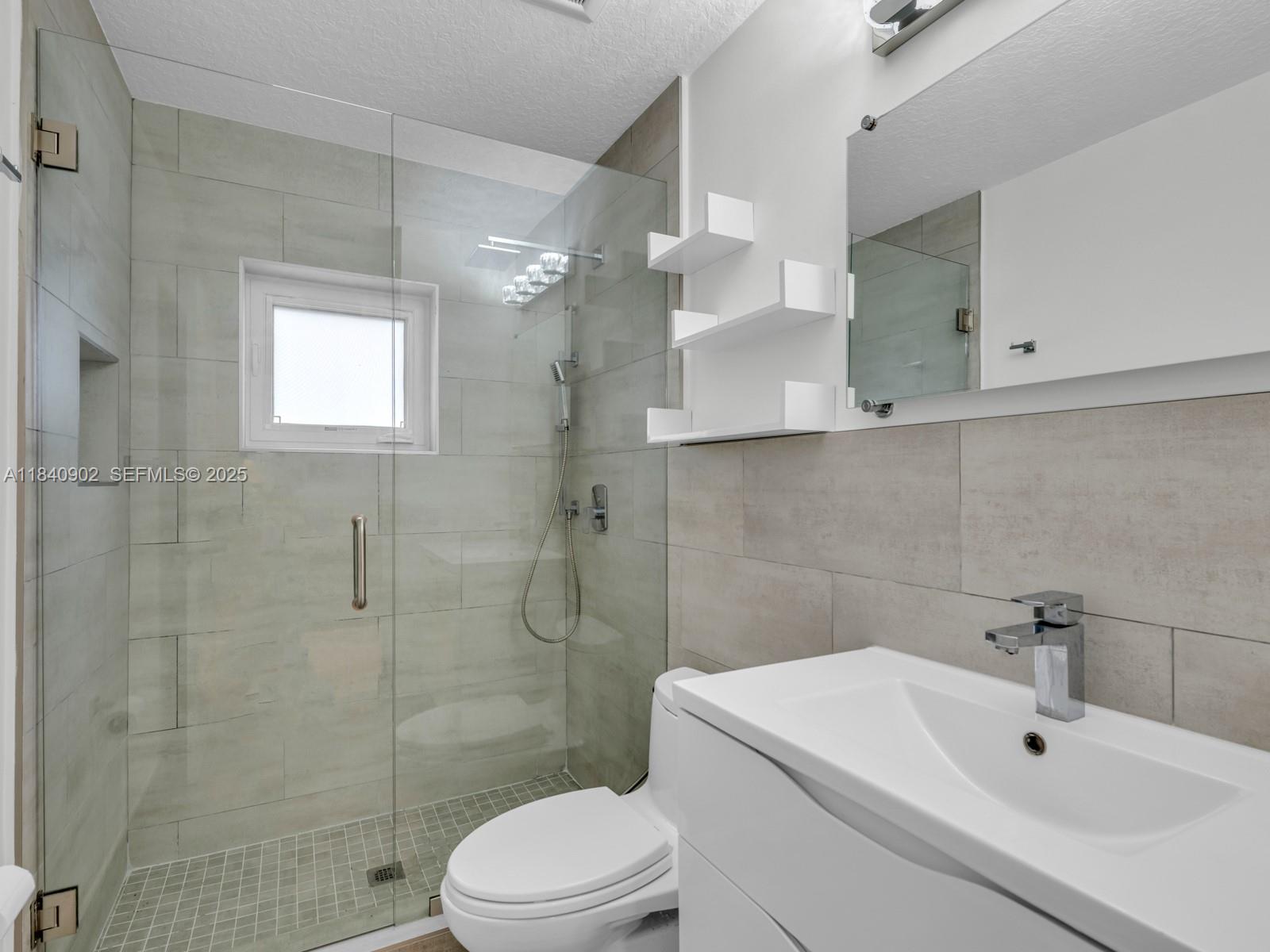 933 Falling Water Road Weston, FL 33326 - Photo 34 of 58 a bathroom with a sink a toilet and shower