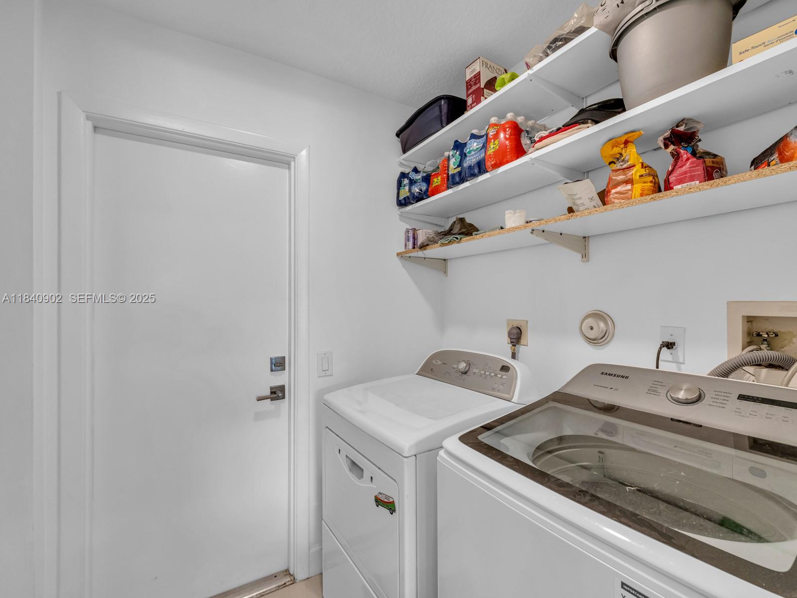 933 Falling Water Road Weston, FL 33326 - Photo 36 of 58 a utility room with dryer and washer