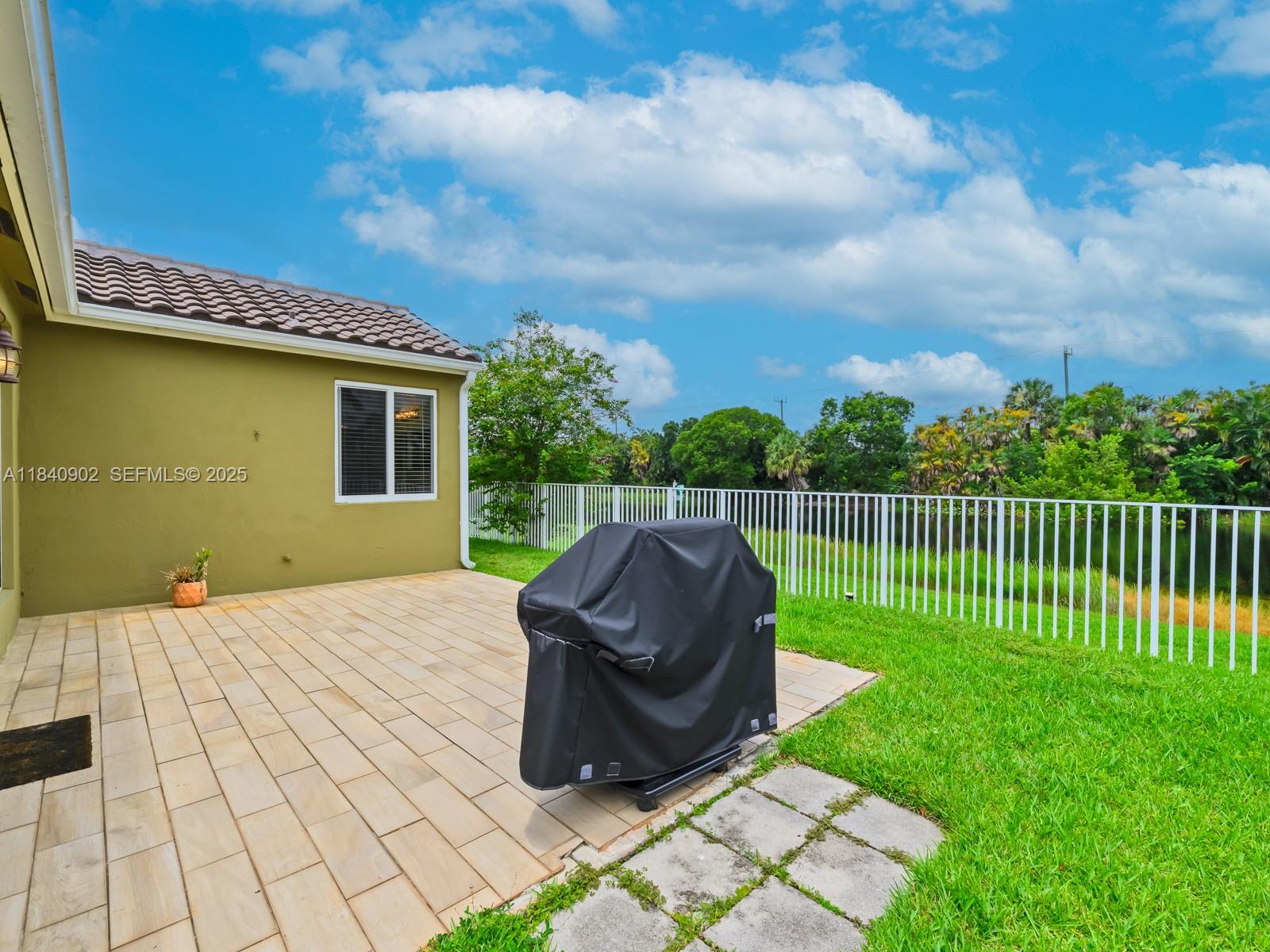 933 Falling Water Road Weston, FL 33326 - Photo 42 of 58 a view of a backyard with wooden fence