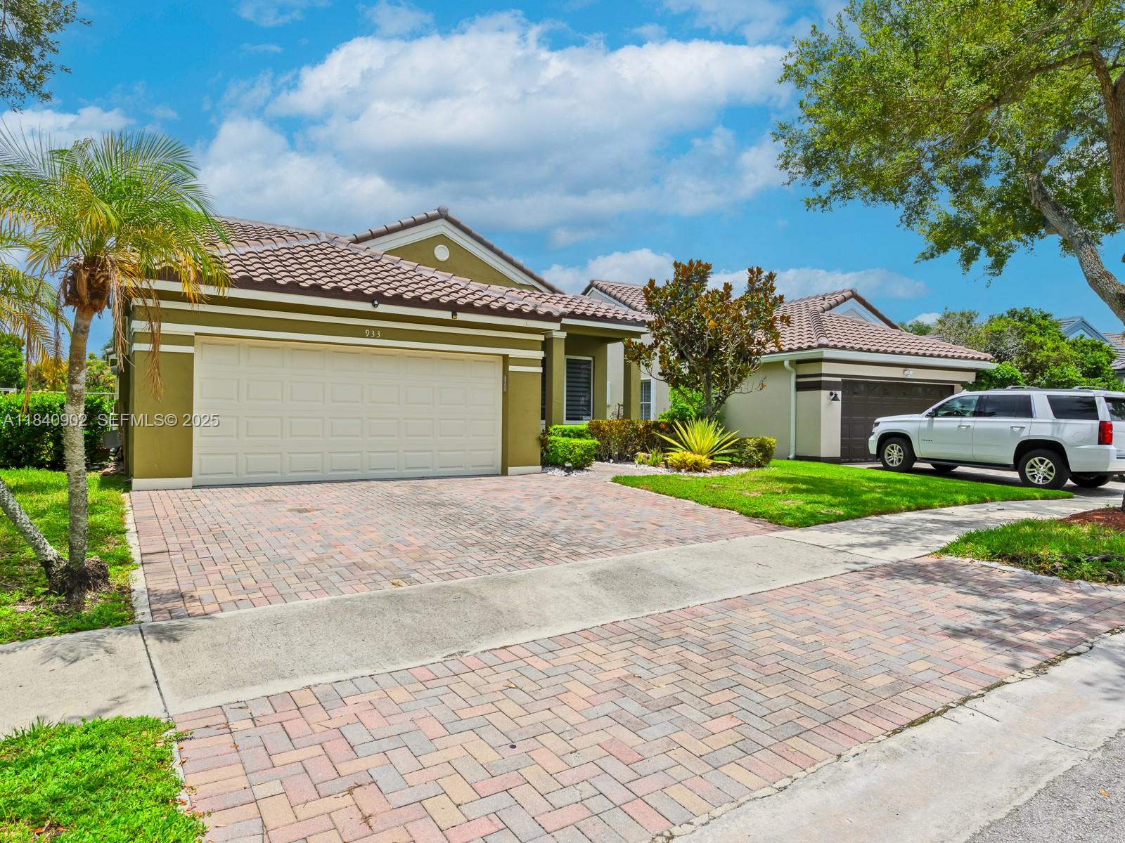 933 Falling Water Road Weston, FL 33326 - Photo 5 of 58 a front view of a house with a yard and garage