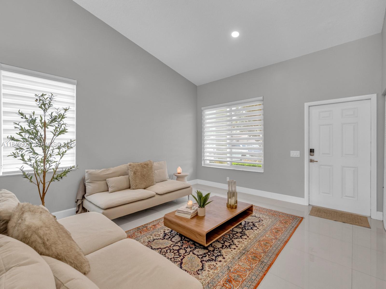 933 Falling Water Road Weston, FL 33326 - Photo 8 of 58 a living room with furniture and a rug