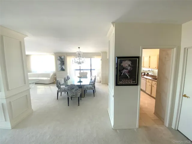 a living room with furniture a dining table and a refrigerator