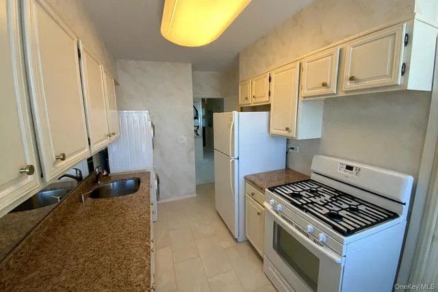a kitchen with wooden cabinets and a stove top oven