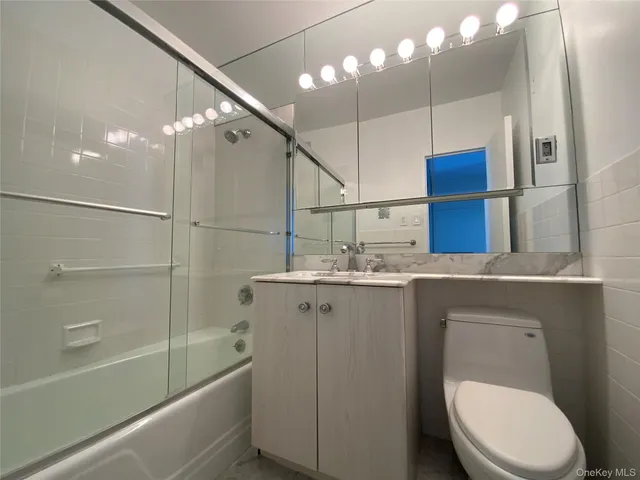 a bathroom with a sink a toilet and bathtub
