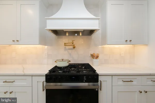 a close view of a stove a microwave and cabinets