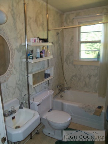 128 Jake Blackburn Road Lansing, NC 28643 - Photo 13 of 16 a bathroom with a sink toilet and shower