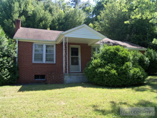 128 Jake Blackburn Road Lansing, NC 28643 - Photo 2 of 16 a front view of a house with a yard