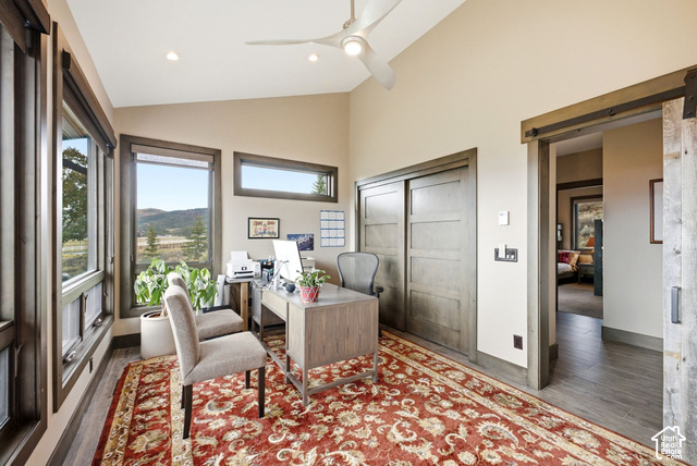 1130 Pace Road Park City, UT 84098 - Photo 49 of 73 Vaulted ceiling with a ceiling fan, multiple windows with dark trim, wood-finish flooring, and a sliding barn door