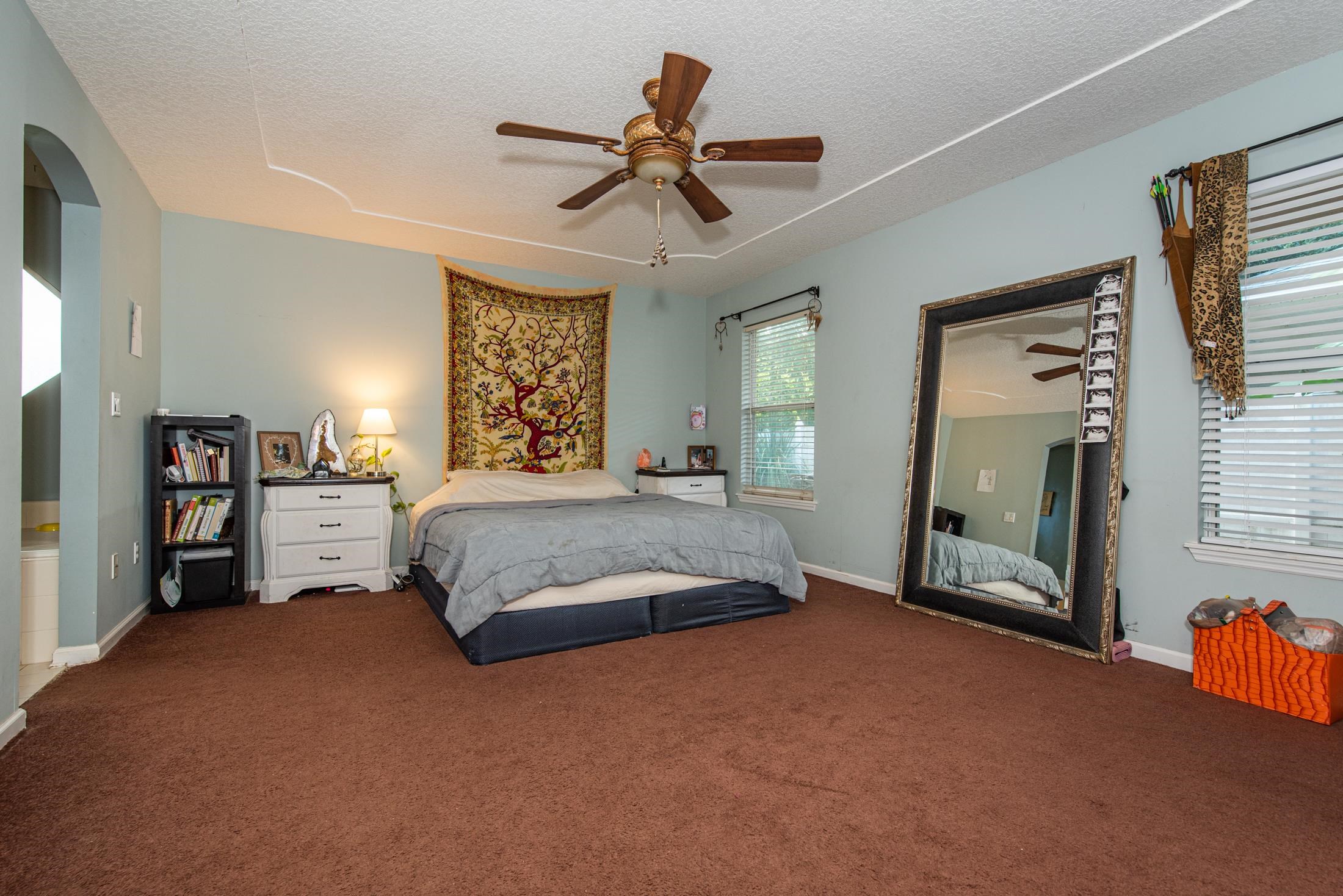 1809 Keswick Road St. Augustine, FL 32084 - Photo 13 of 39 a spacious bedroom with a bed and a chandelier