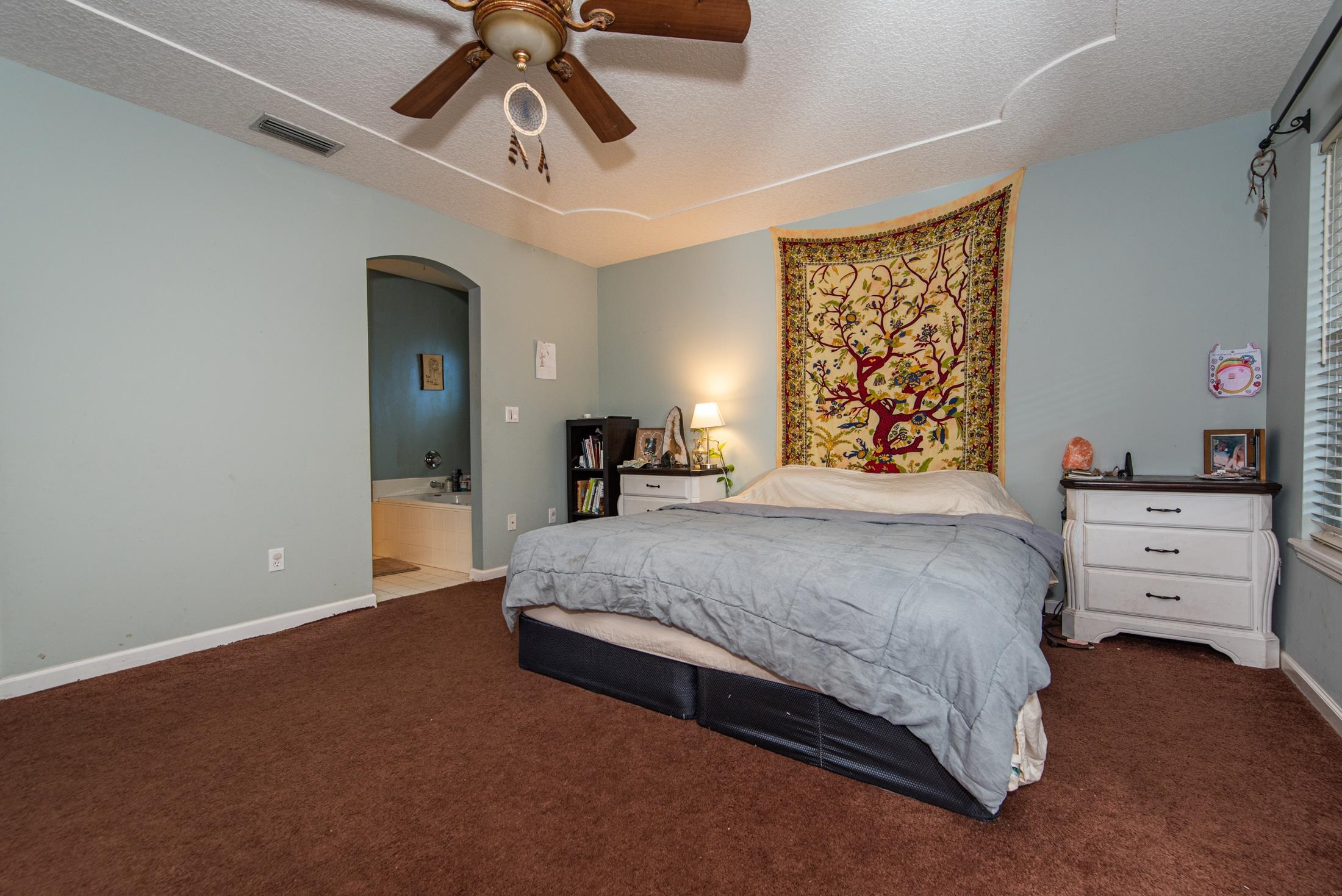 1809 Keswick Road St. Augustine, FL 32084 - Photo 14 of 39 a spacious bedroom with a bed and a chandelier