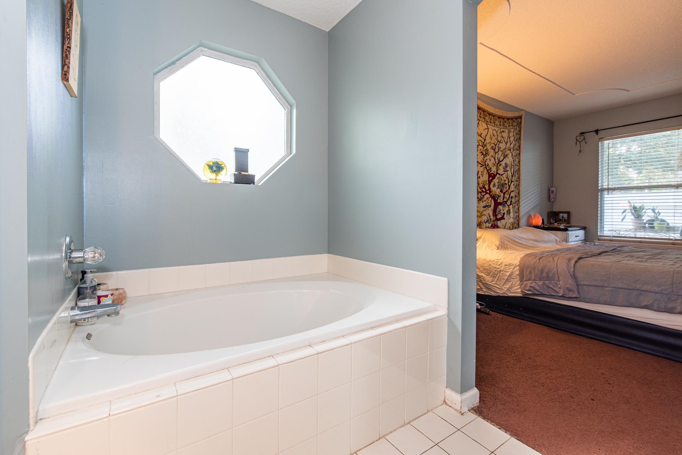 1809 Keswick Road St. Augustine, FL 32084 - Photo 17 of 39 a bathroom with a tub and a window