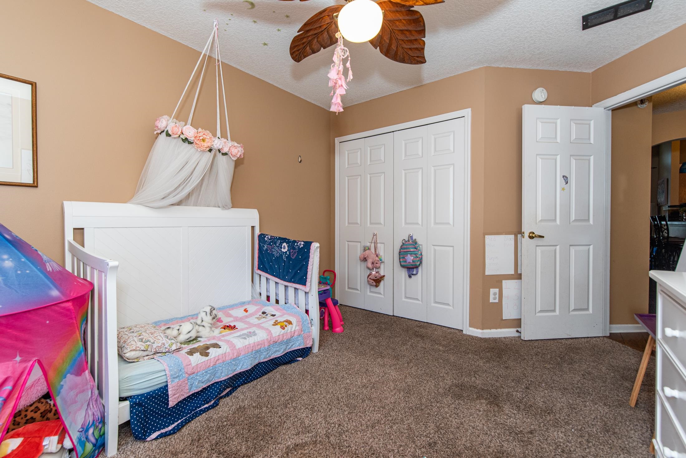 1809 Keswick Road St. Augustine, FL 32084 - Photo 22 of 39 a bedroom with a bed and a chandelier