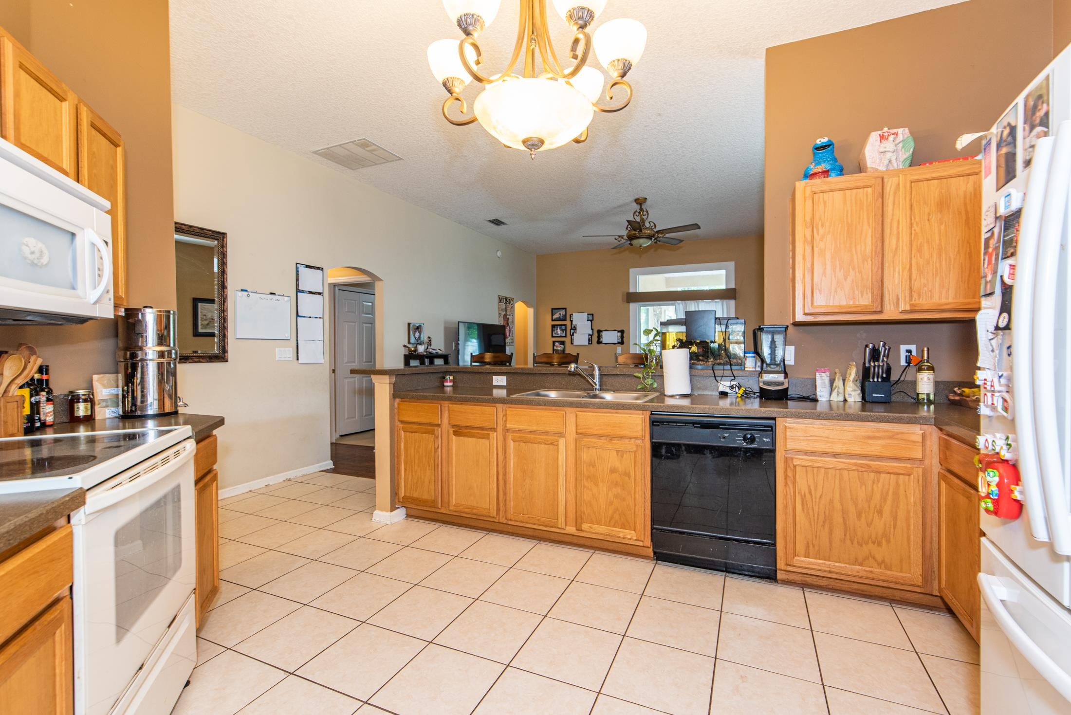 1809 Keswick Road St. Augustine, FL 32084 - Photo 7 of 39 a kitchen with stainless steel appliances granite countertop a stove sink and cabinets