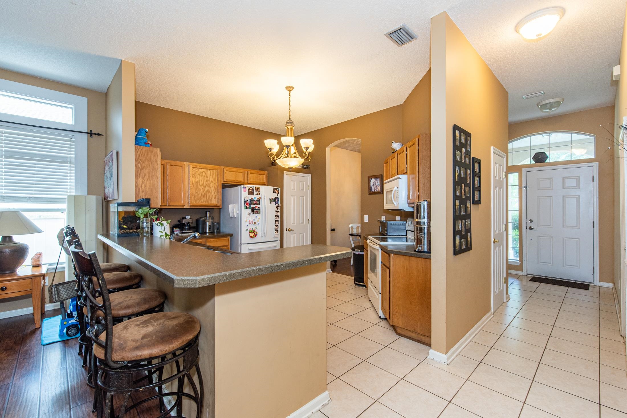 1809 Keswick Road St. Augustine, FL 32084 - Photo 9 of 39 a view of a kitchen with kitchen island dining table and a chandelier