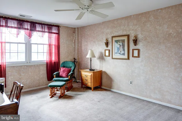 a bedroom with furniture and a window