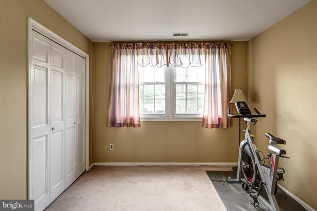 a view of a hallway with wooden cabinets and entryway