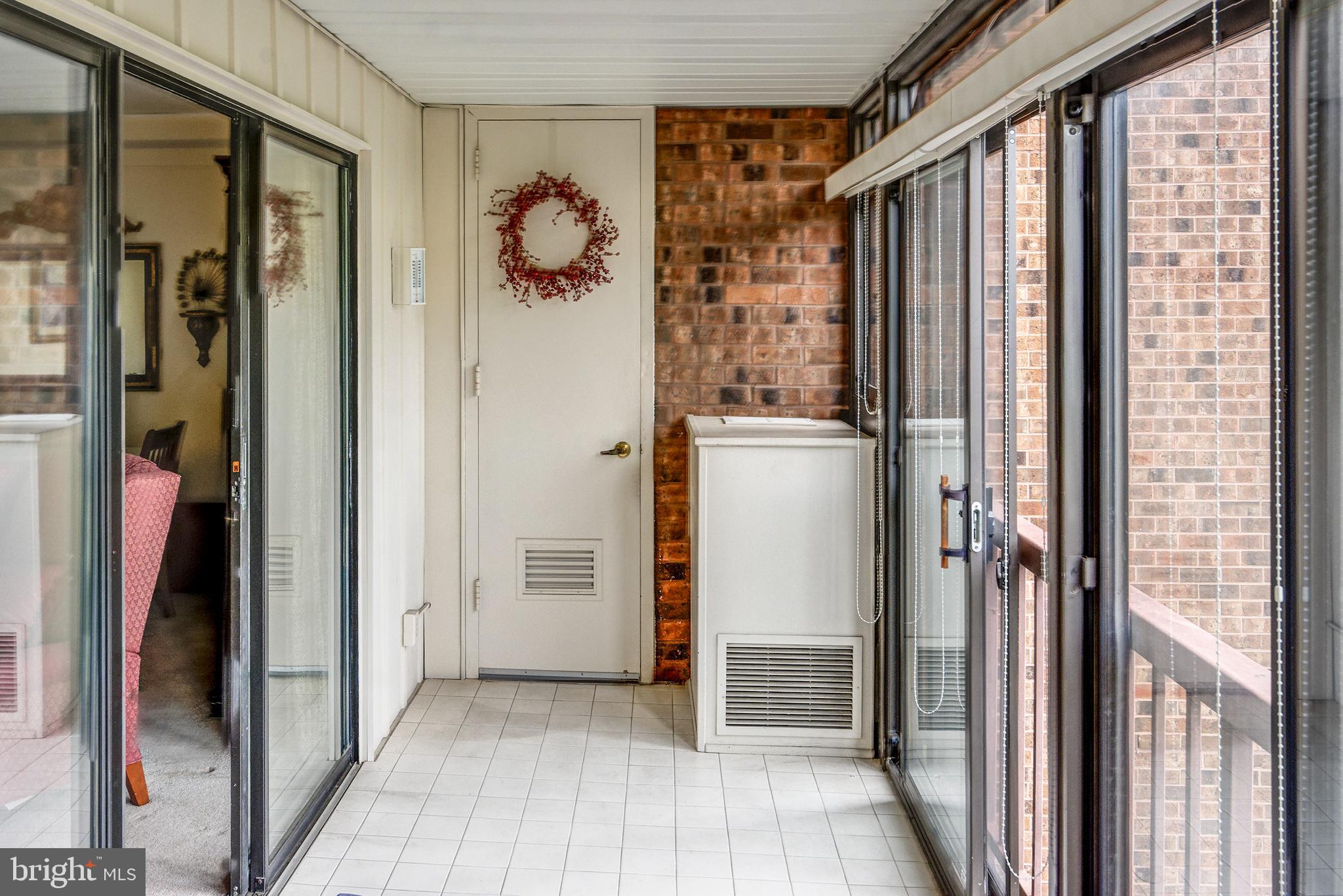 209 Haddonfield Commons, Unit 209 Haddonfield, NJ 08033 - Photo 19 of 21 a view of a hallway with wooden cabinets and entryway