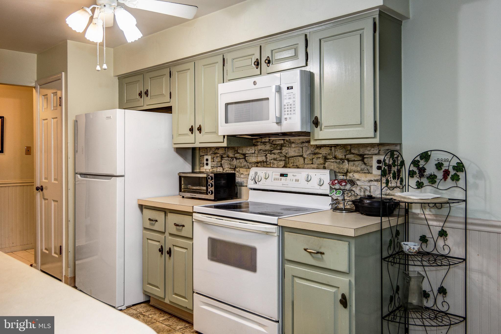 209 Haddonfield Commons, Unit 209 Haddonfield, NJ 08033 - Photo 6 of 21 a kitchen with a stove cabinets and refrigerator