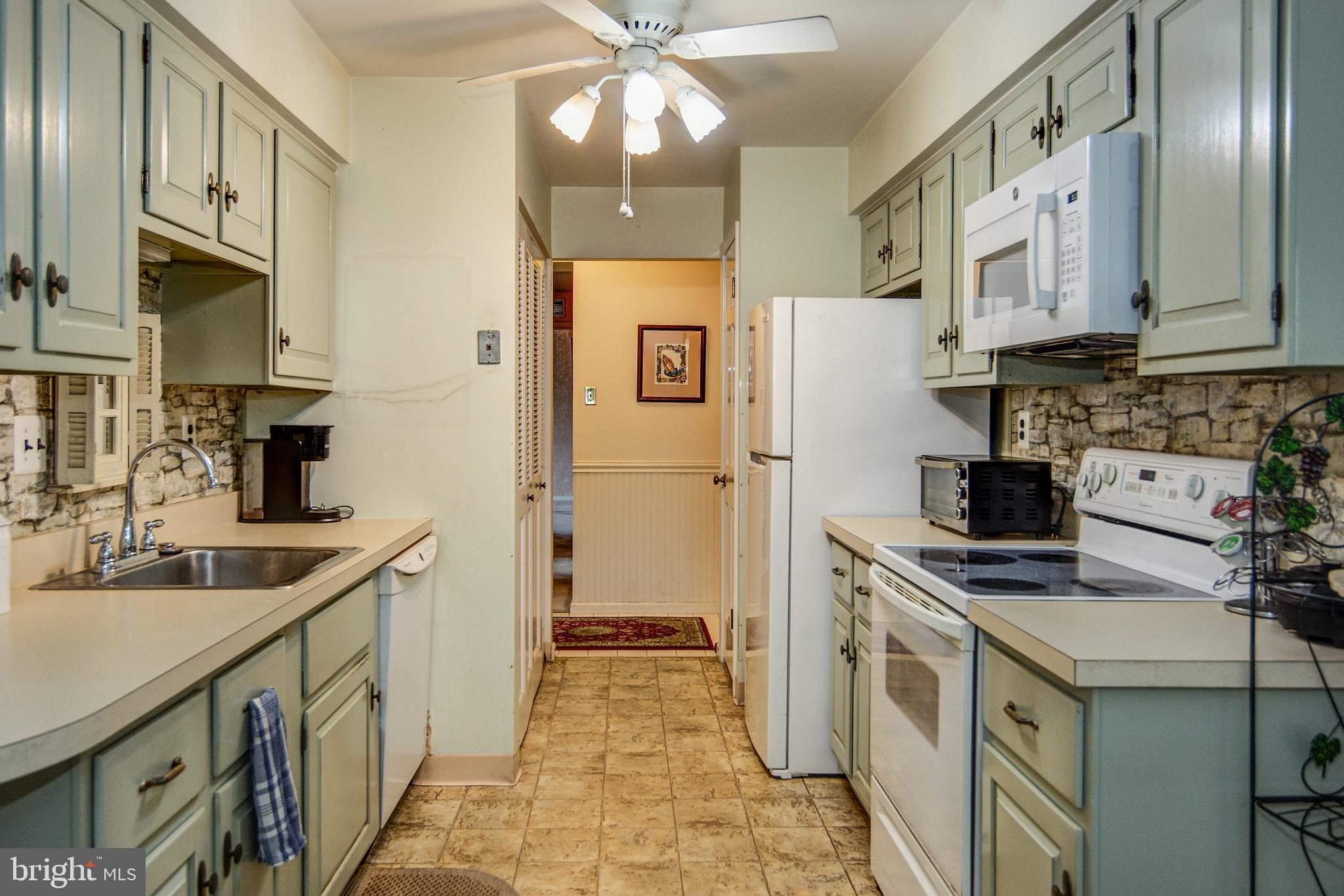 209 Haddonfield Commons, Unit 209 Haddonfield, NJ 08033 - Photo 9 of 21 a kitchen with stainless steel appliances a sink stove refrigerator and cabinets