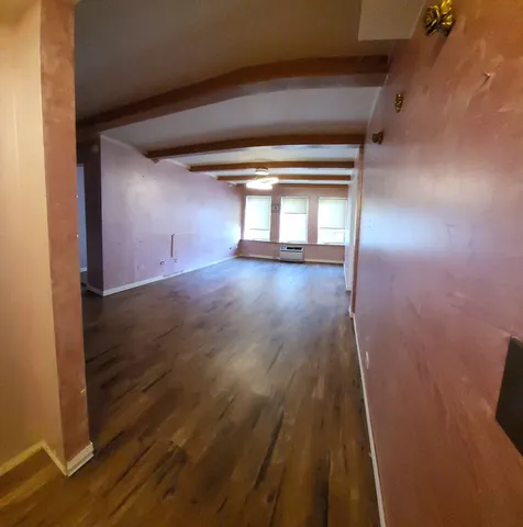 wooden floor and window in an empty room