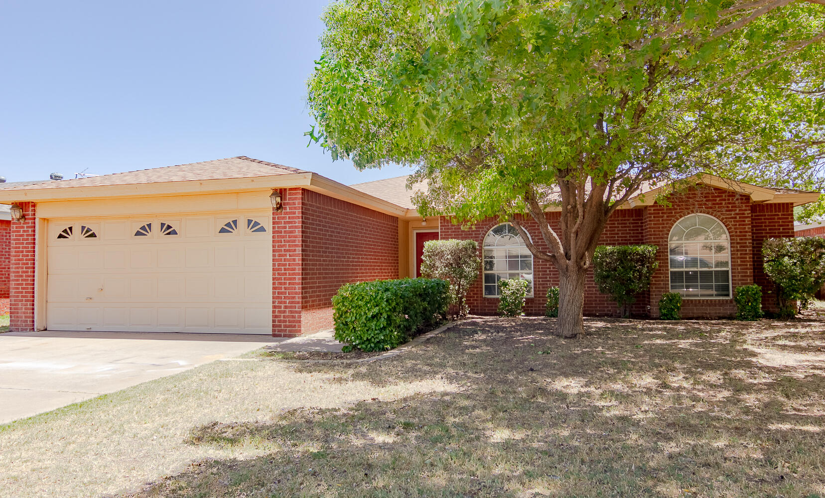 1003 Juneau Avenue Lubbock, TX 79416 - Photo 1 of 21 a front view of a house with a yard
