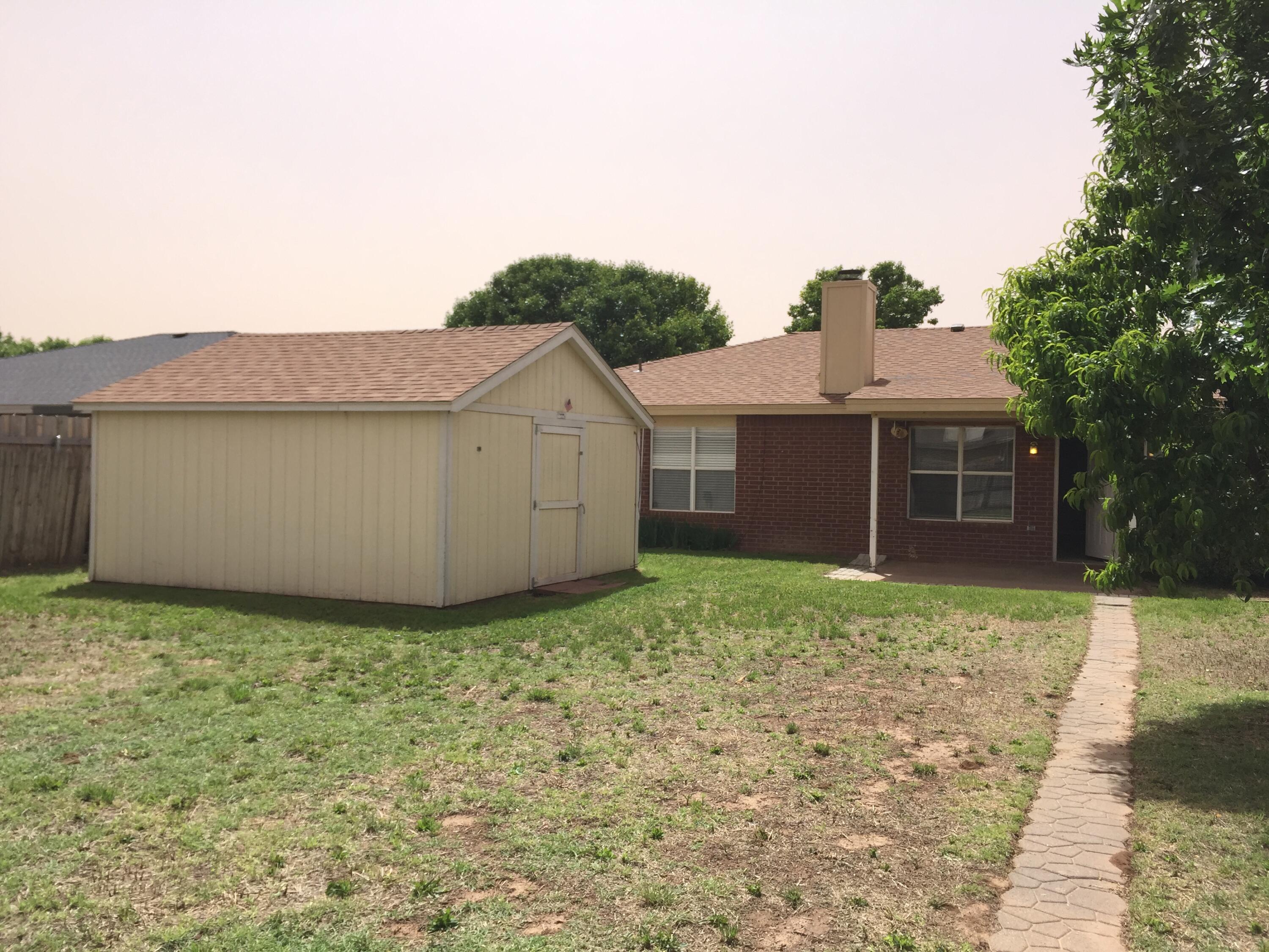 1003 Juneau Avenue Lubbock, TX 79416 - Photo 20 of 21 a view of a house with a yard and large tree