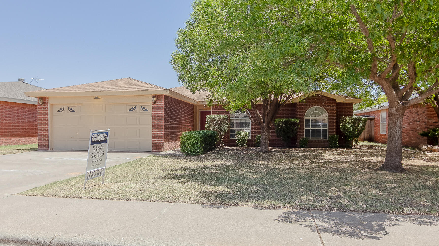 1003 Juneau Avenue Lubbock, TX 79416 - Photo 2 of 21 a front view of a house with a yard and garage