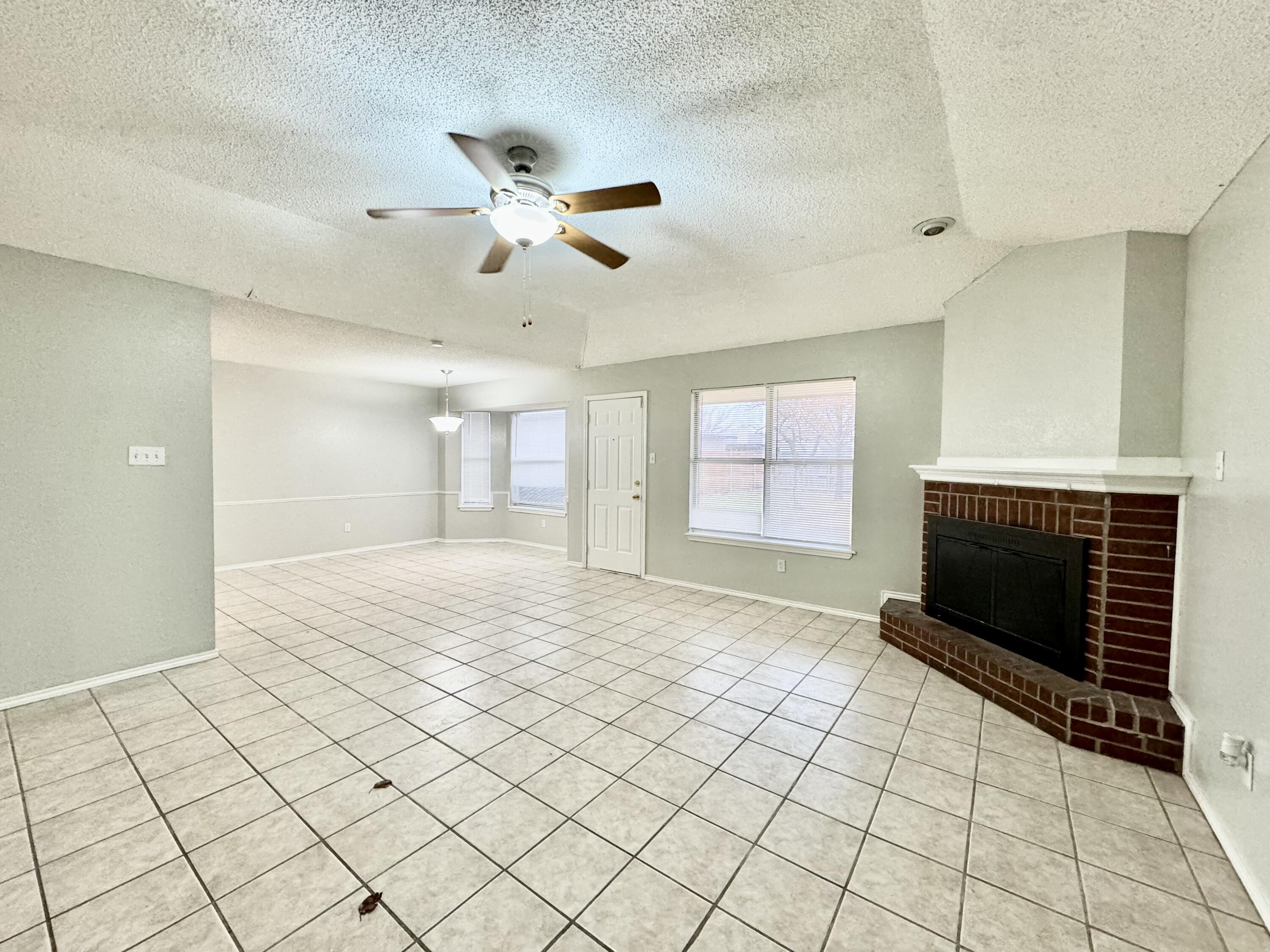 1003 Juneau Avenue Lubbock, TX 79416 - Photo 4 of 21 a view of an empty room and fire place
