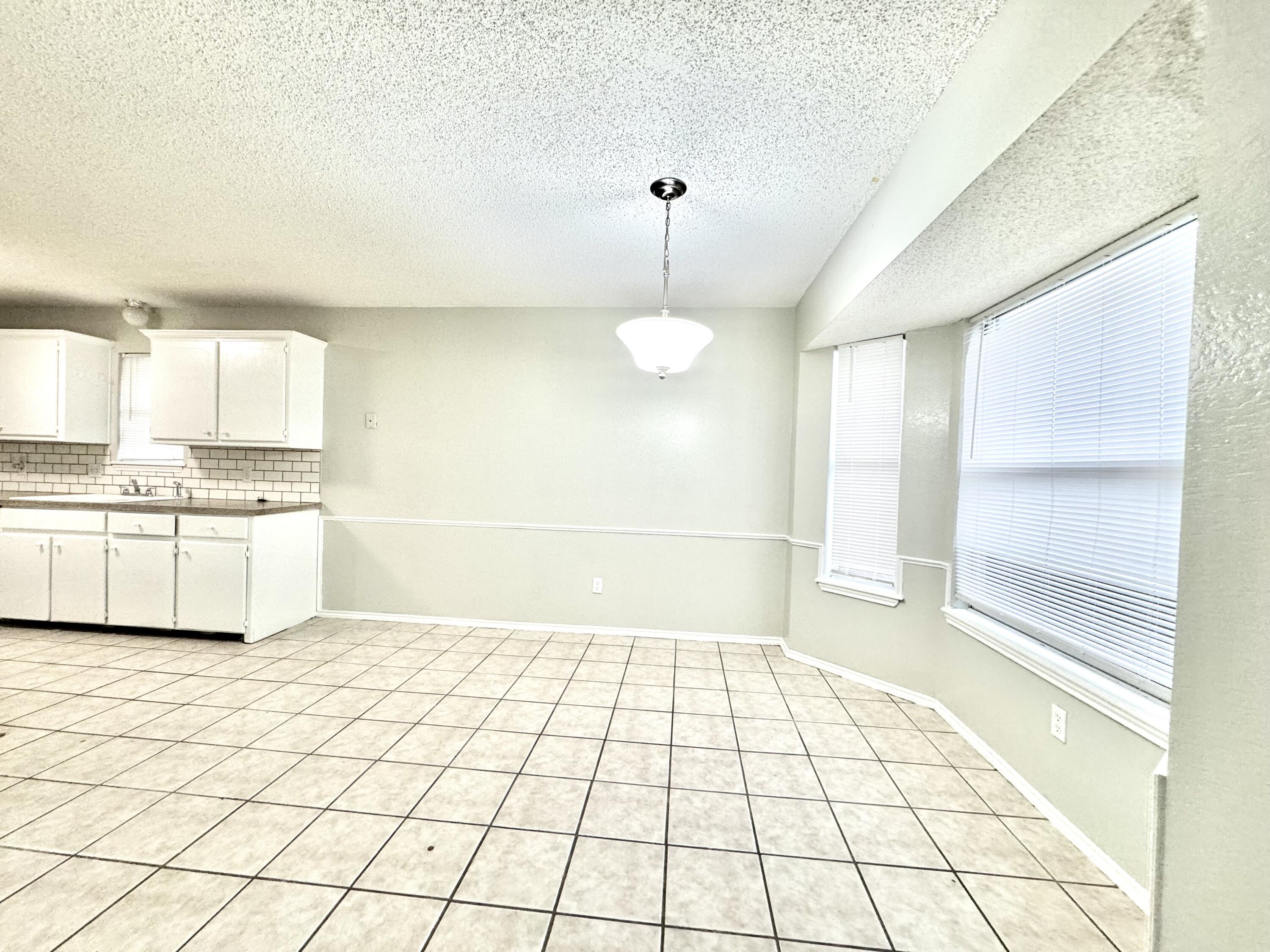 1003 Juneau Avenue Lubbock, TX 79416 - Photo 6 of 21 a view of a kitchen with a sink and a stove top oven