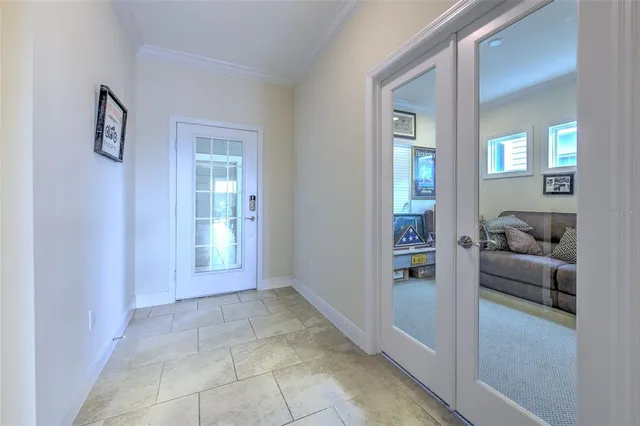 a bedroom with a bed a lamp and paintings on the wall