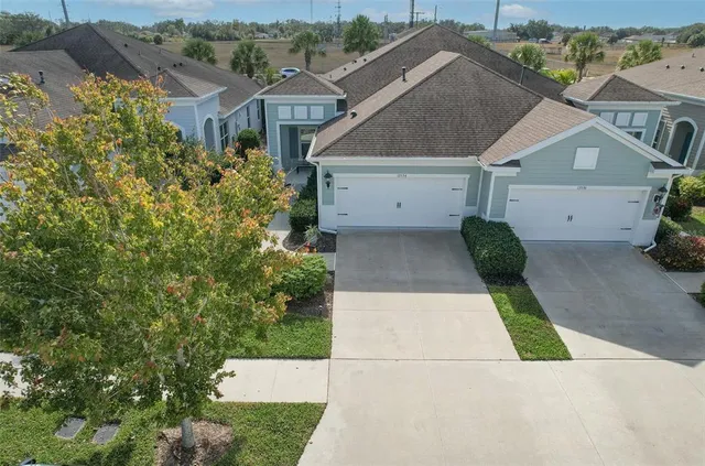 an aerial view of a house with a yard and garden