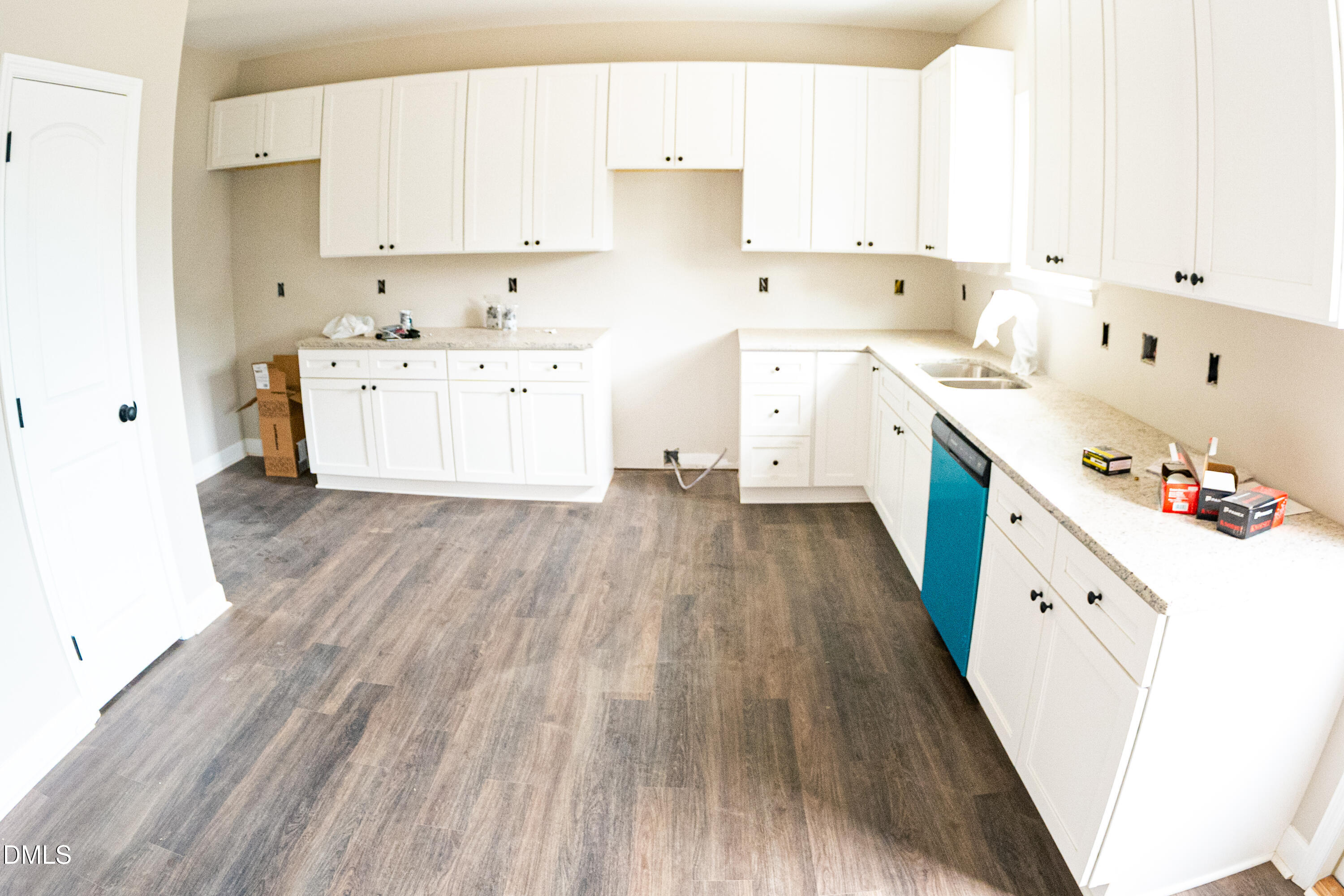 125 Wilson Street Erwin, NC 28339 - Photo 11 of 22 a large white kitchen with wooden floors and sink