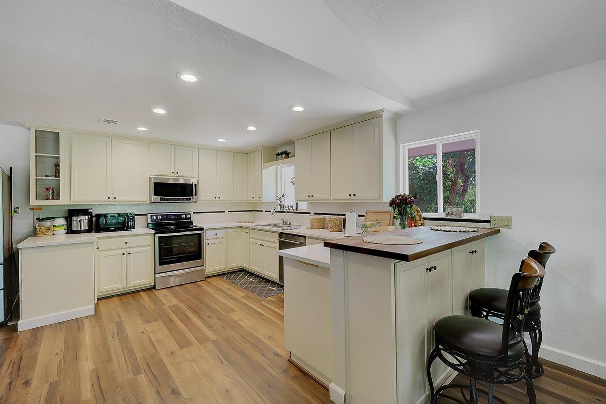 10307 Alta Mesa Road Wilton, CA 95693 - Photo 11 of 58 a kitchen with a sink white cabinets and white appliances