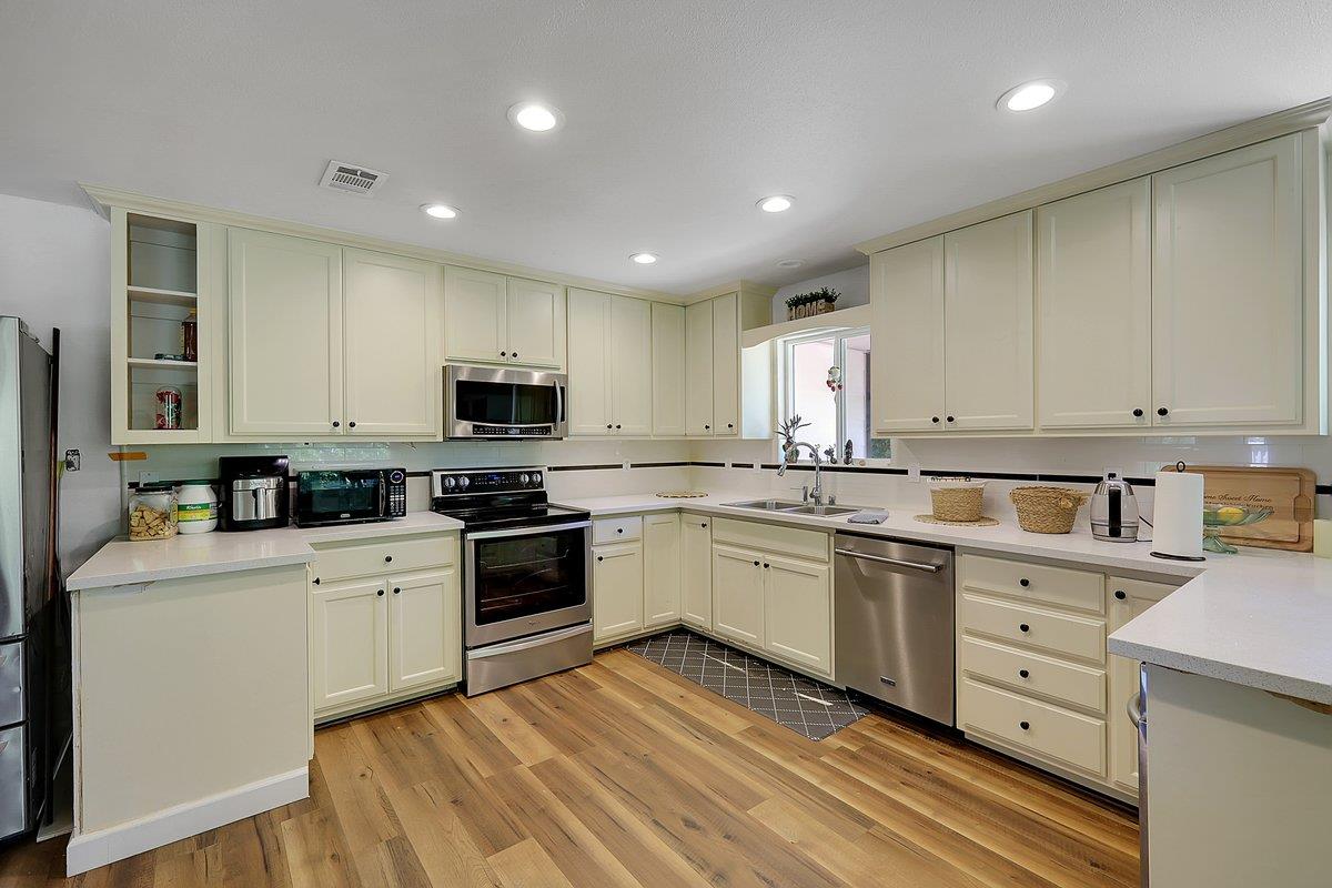 10307 Alta Mesa Road Wilton, CA 95693 - Photo 12 of 58 a kitchen with granite countertop appliances cabinets and a sink