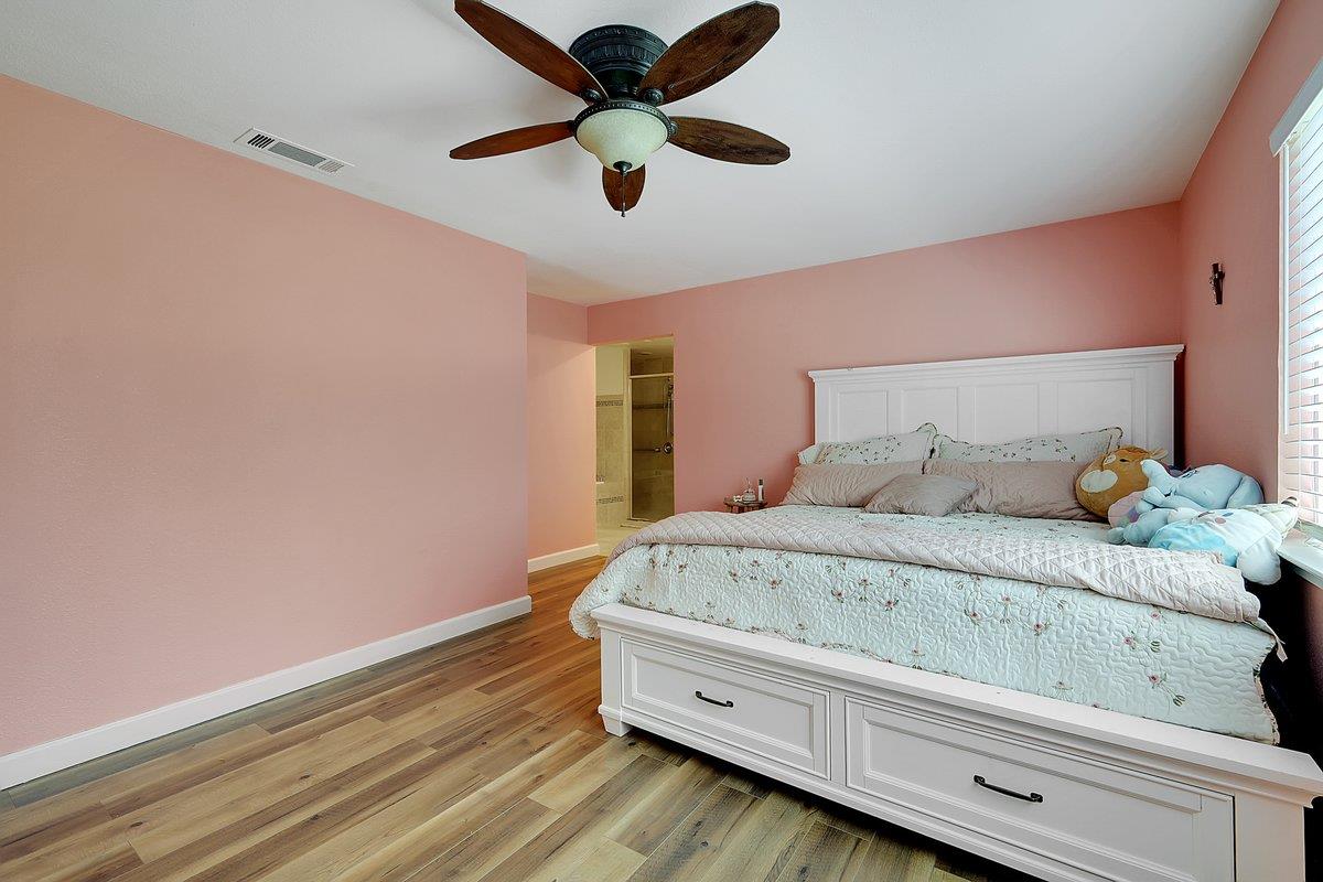 10307 Alta Mesa Road Wilton, CA 95693 - Photo 17 of 58 a bedroom with a bed and a ceiling fan