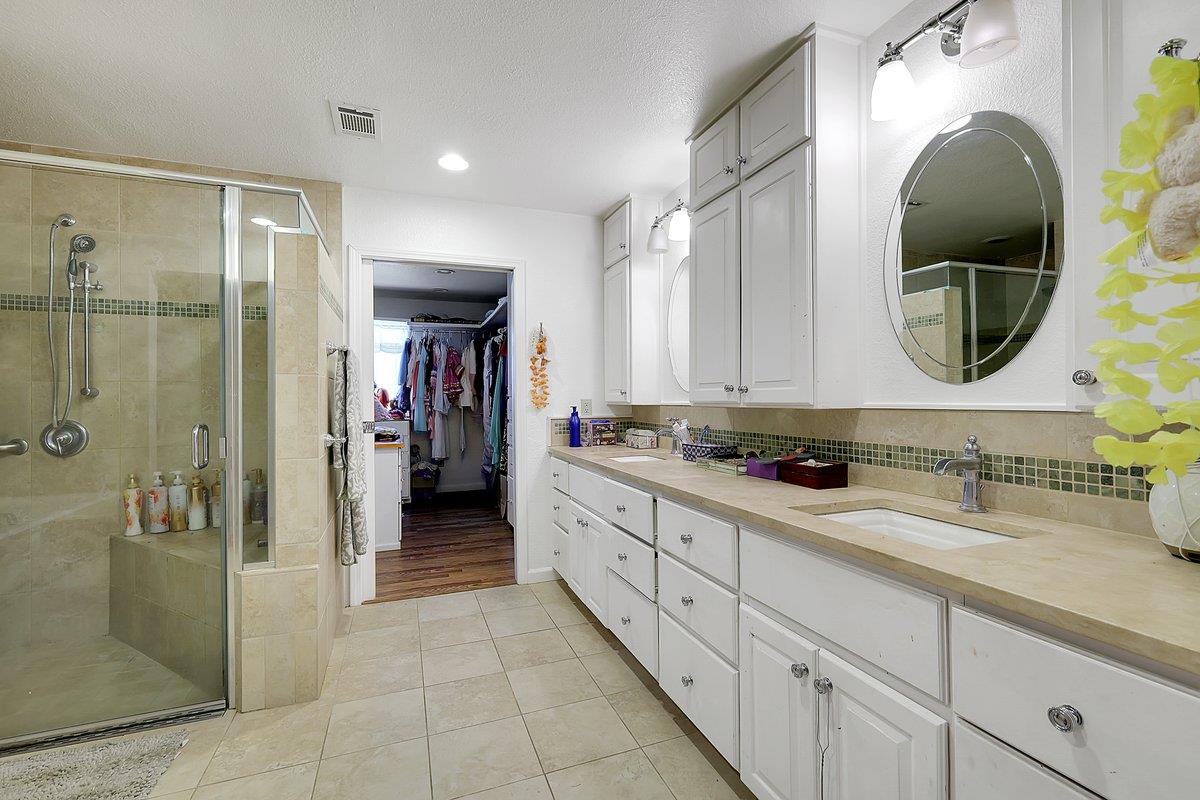 10307 Alta Mesa Road Wilton, CA 95693 - Photo 18 of 58 a bathroom with a double vanity sink and a mirror