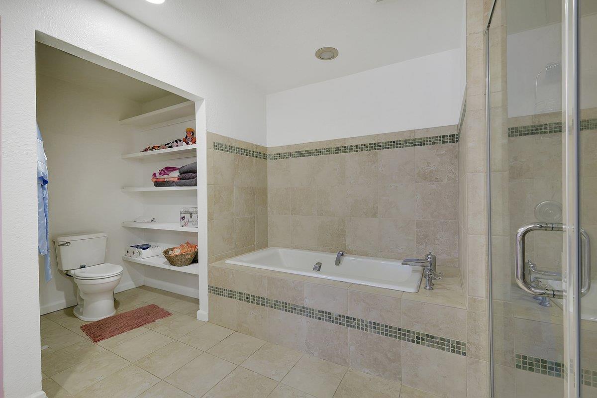 10307 Alta Mesa Road Wilton, CA 95693 - Photo 20 of 58 a spacious bathroom with a bathtub and a shower