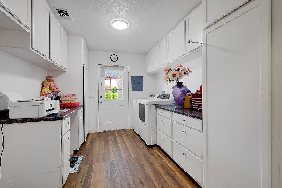 10307 Alta Mesa Road Wilton, CA 95693 - Photo 25 of 58 a kitchen with wooden floor and cabinets