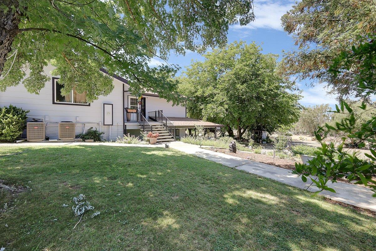 10307 Alta Mesa Road Wilton, CA 95693 - Photo 3 of 58 a front view of house with yard and trees