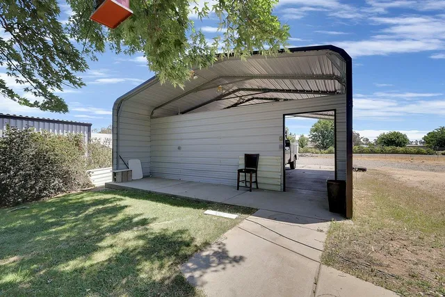 a view of a house with a yard and car parked
