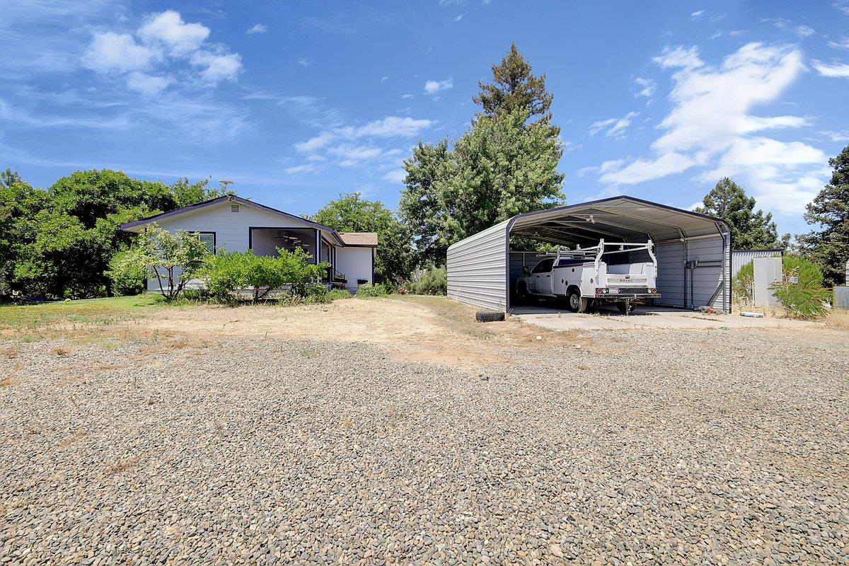 10307 Alta Mesa Road Wilton, CA 95693 - Photo 42 of 58 a car parked in front of a house with a yard