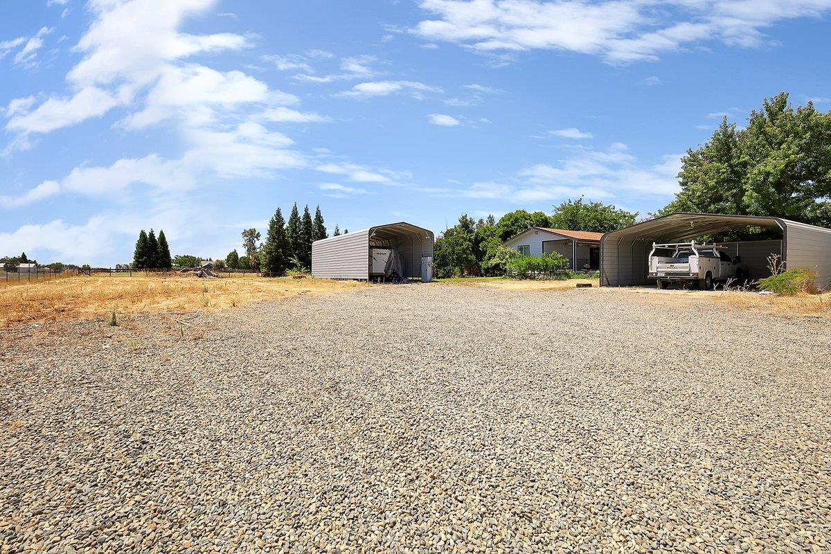 10307 Alta Mesa Road Wilton, CA 95693 - Photo 44 of 58 a view of a house with a yard and car parked