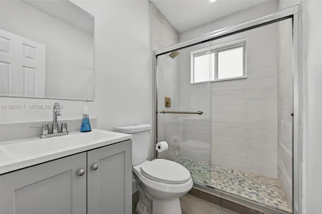 a bathroom with a sink toilet and shower