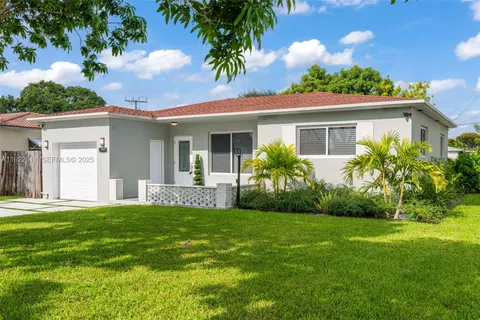 a front view of a house with a garden