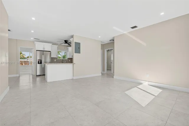 a view of a kitchen with furniture and an empty room