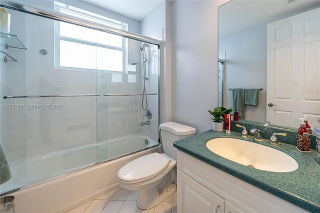 a bathroom with a sink toilet tub and shower