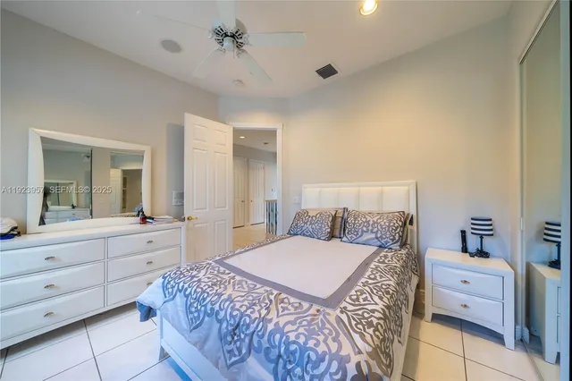 a bedroom with a large bed and a dresser