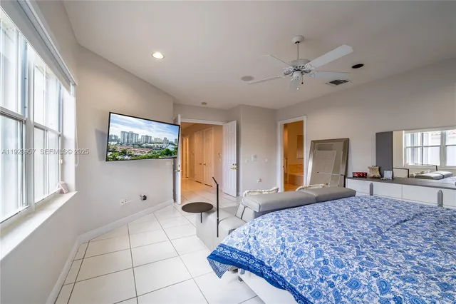 a bedroom with a large bed and a window